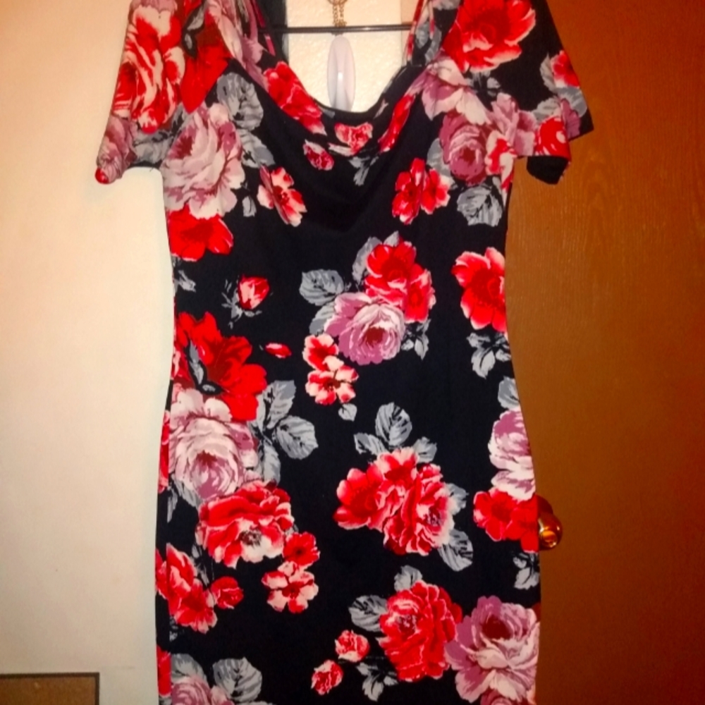 Red and black floral dress hangs off shoulder